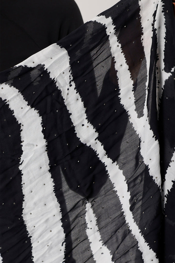 Close-up of a black and white patterned fabric with sequins.