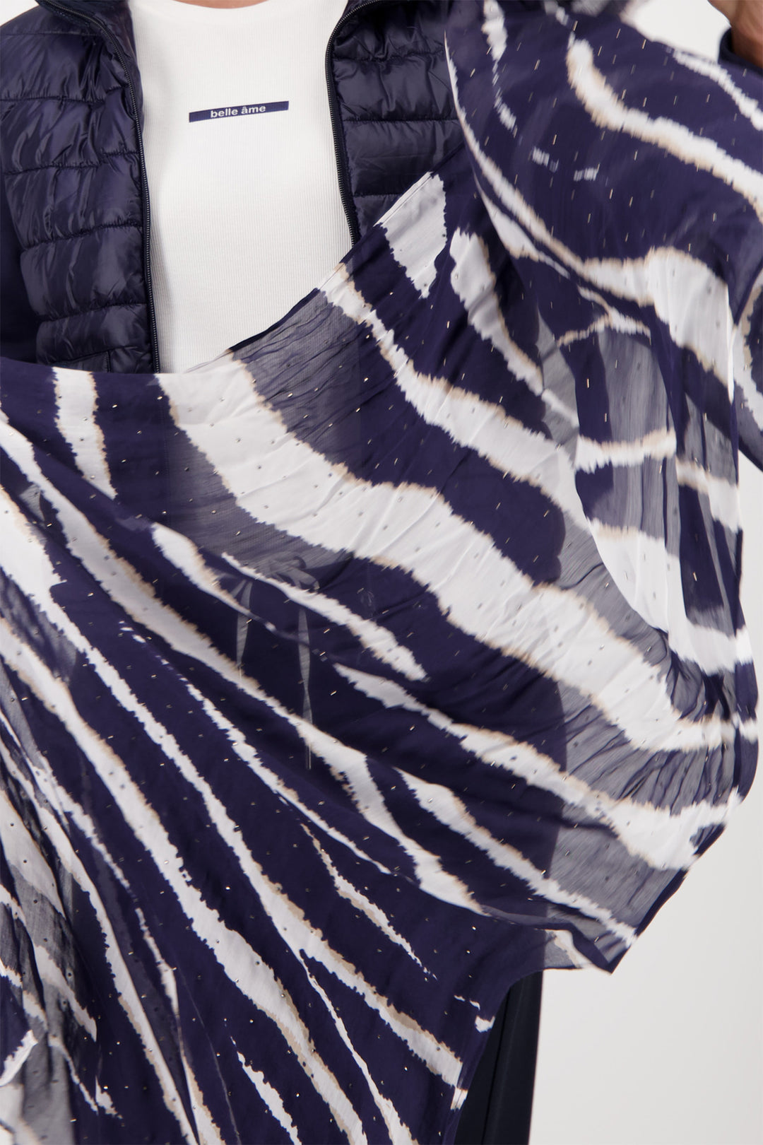 Person wearing a navy and white patterned scarf