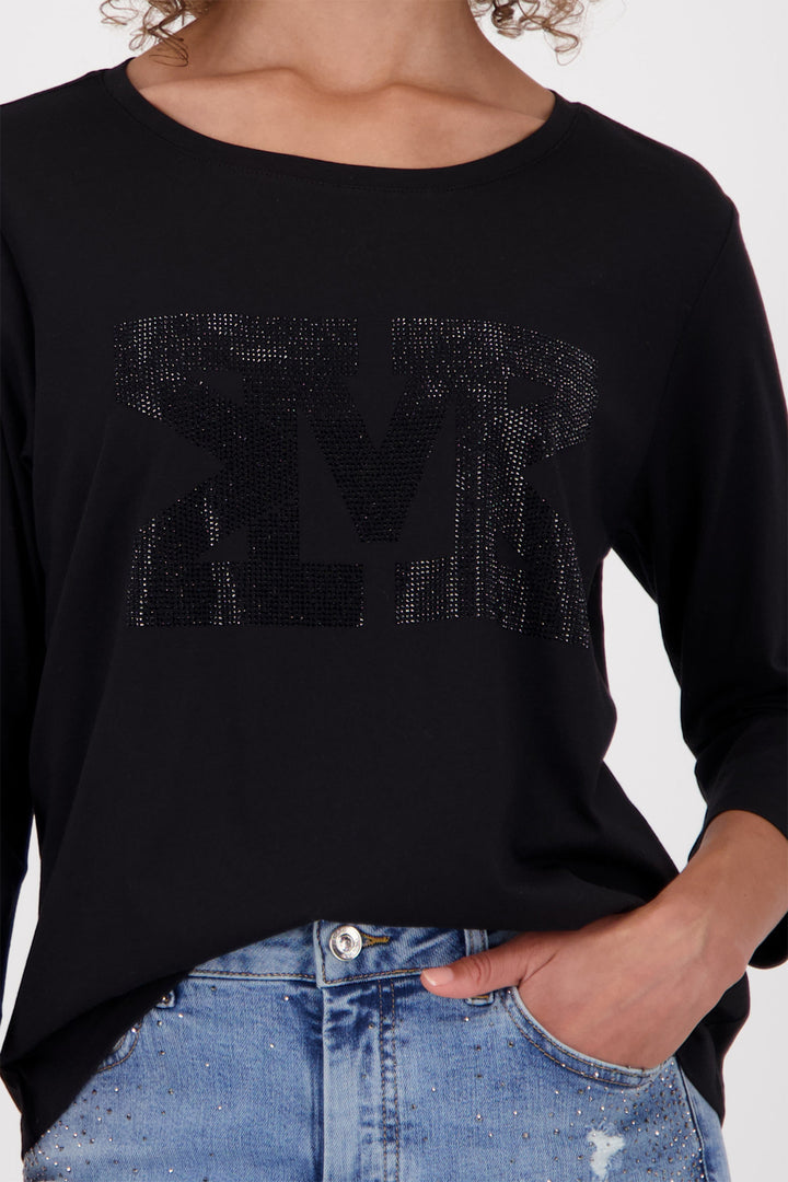 Black long-sleeve top with decorative text on a plain background