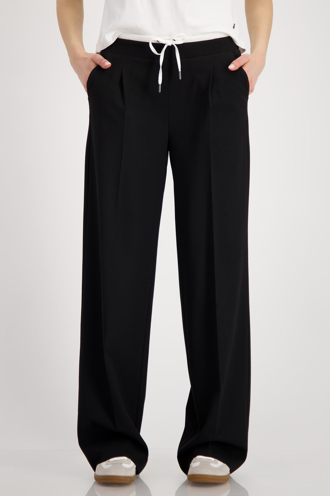 Black wide-leg pants worn by a person on a white background