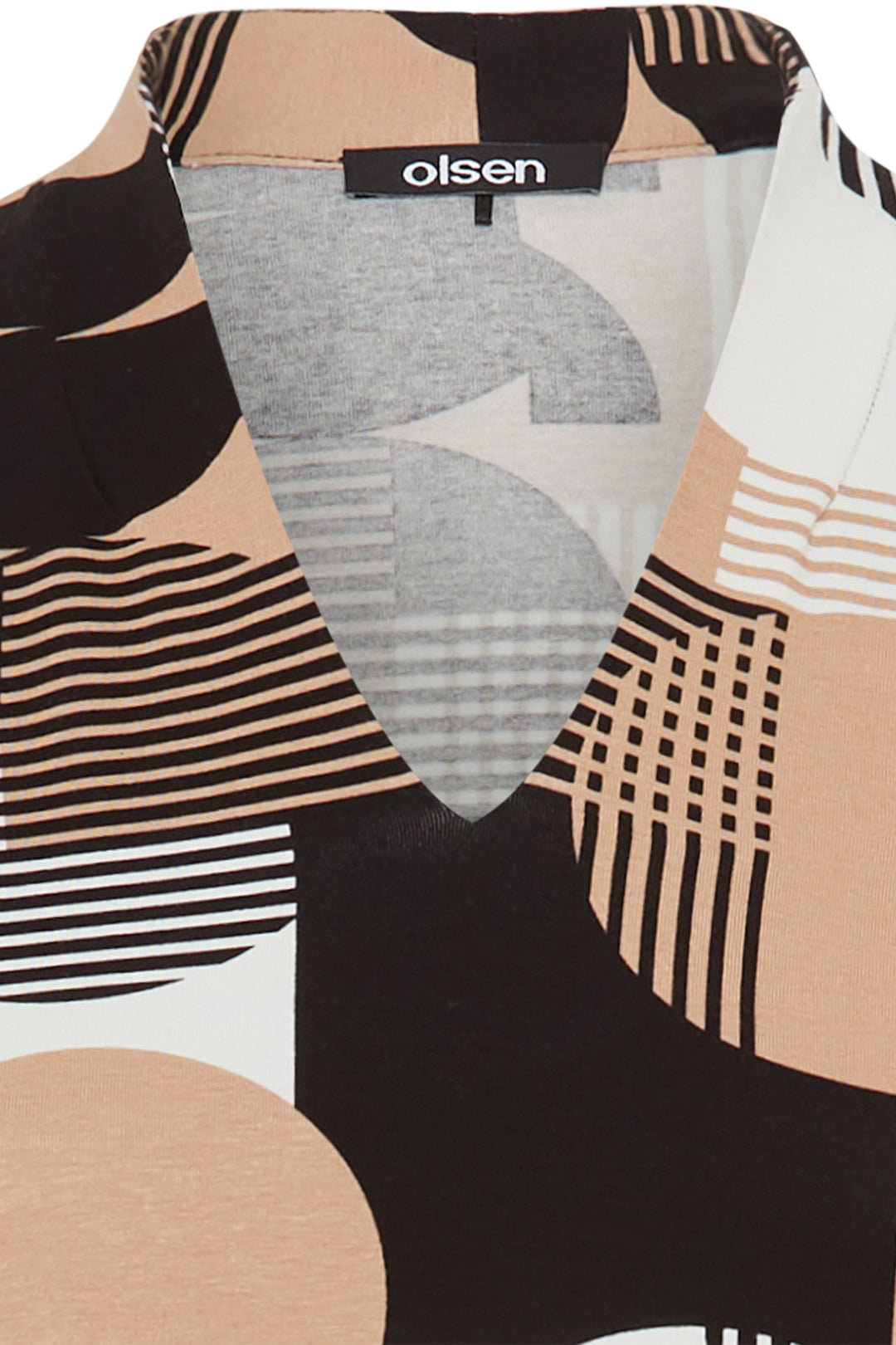 Close-up of a patterned garment with 'olsen' label