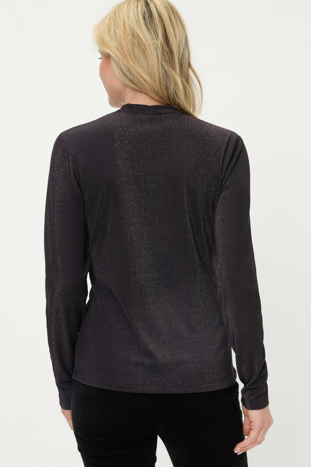 Person wearing a black long-sleeve top on a white background