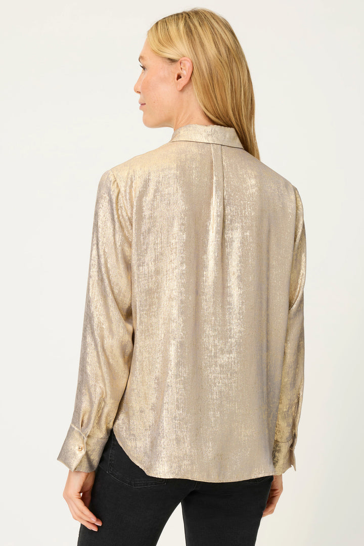 Woman wearing a gold textured blouse on a white background