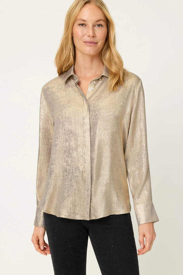 Woman wearing a gold long-sleeve shirt on a white background