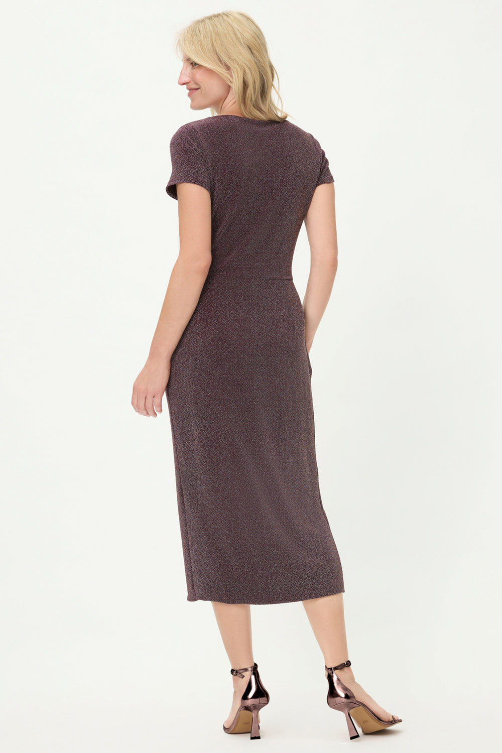 Woman wearing a dark wine dress on a white background