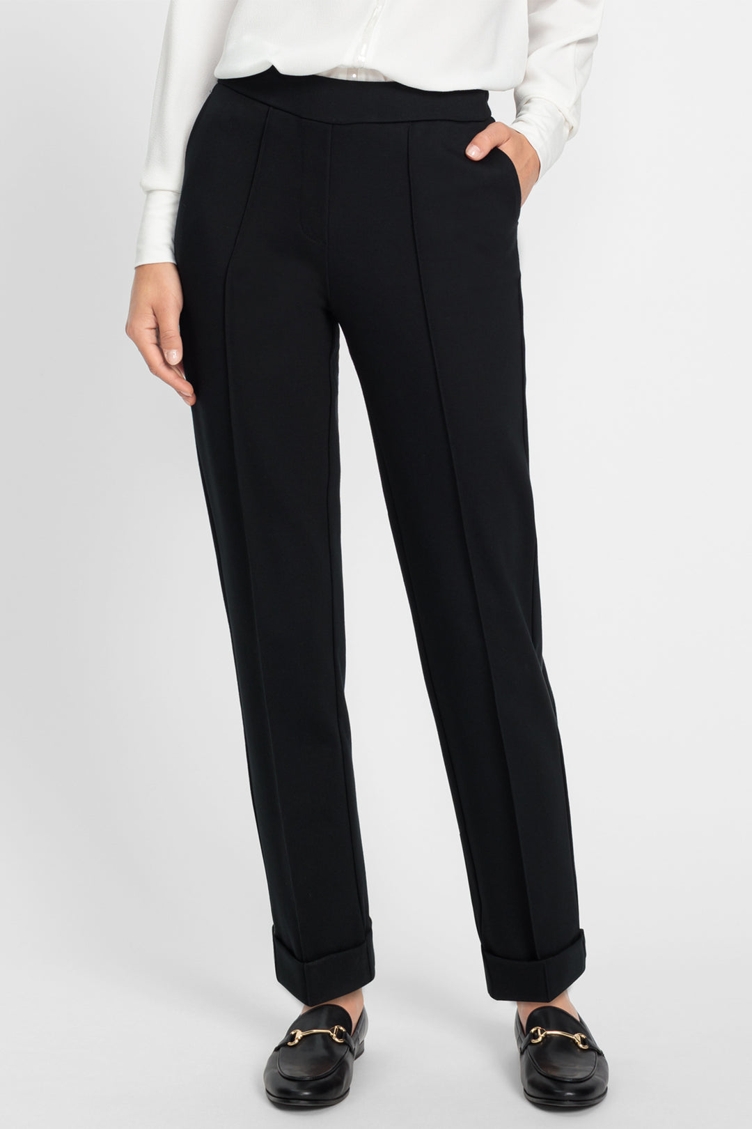 Black pants worn by a person on a white background