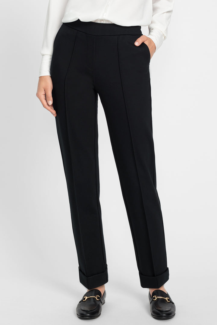 Black pants worn by a person on a white background