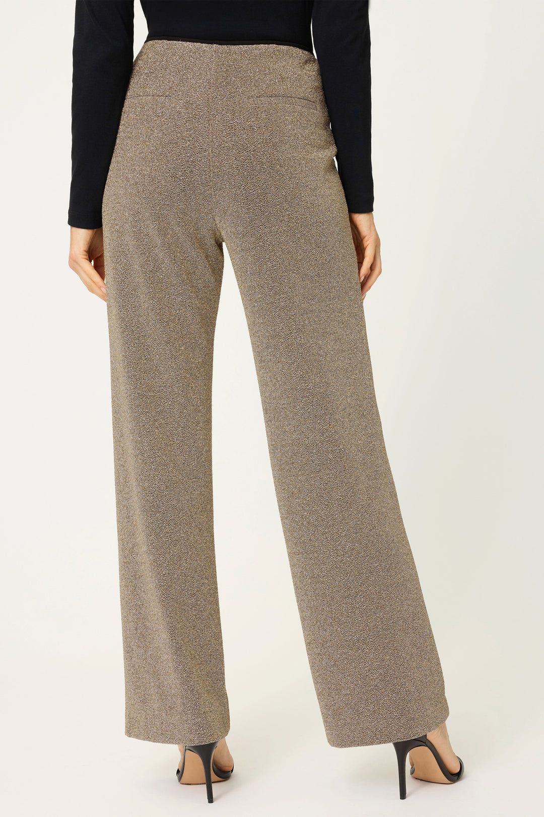 Gold high-waisted pants worn by a person on a white background