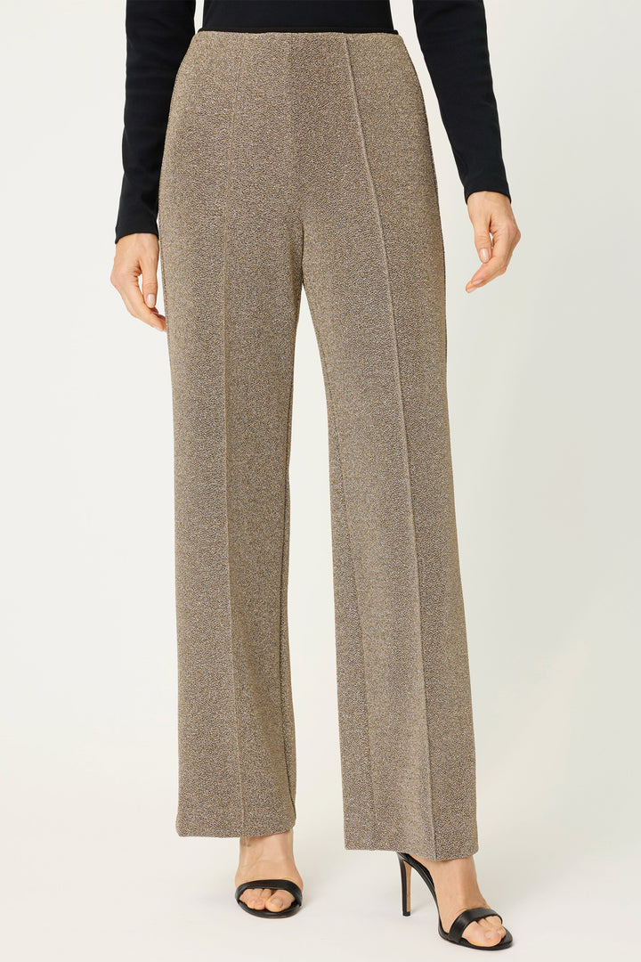 Gold pants worn by a person on a white background