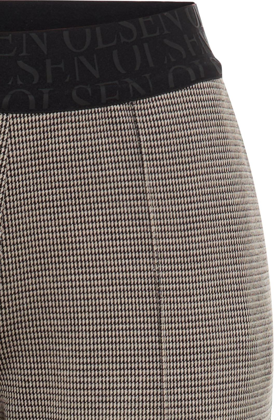 Close-up of a patterned skirt with a brand logo on the waistband.