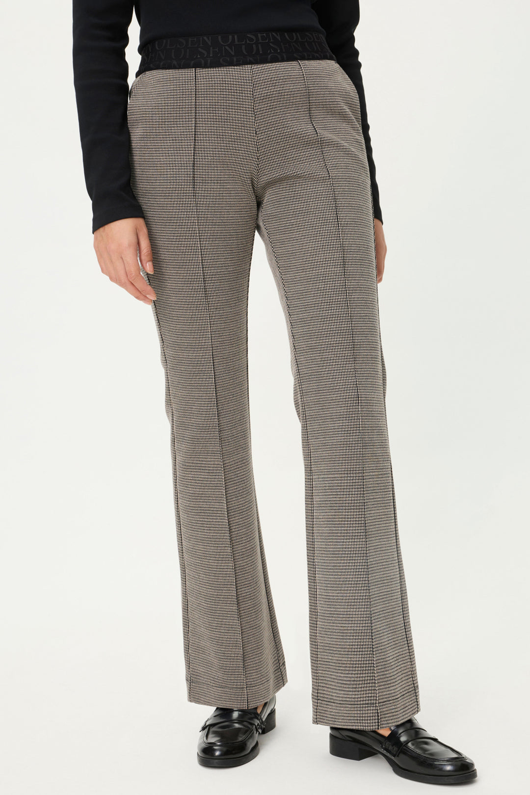Gray checkered pants worn by a person on a white background
