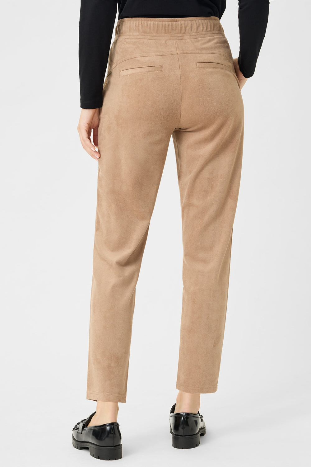 Tan pants worn by a person on a white background