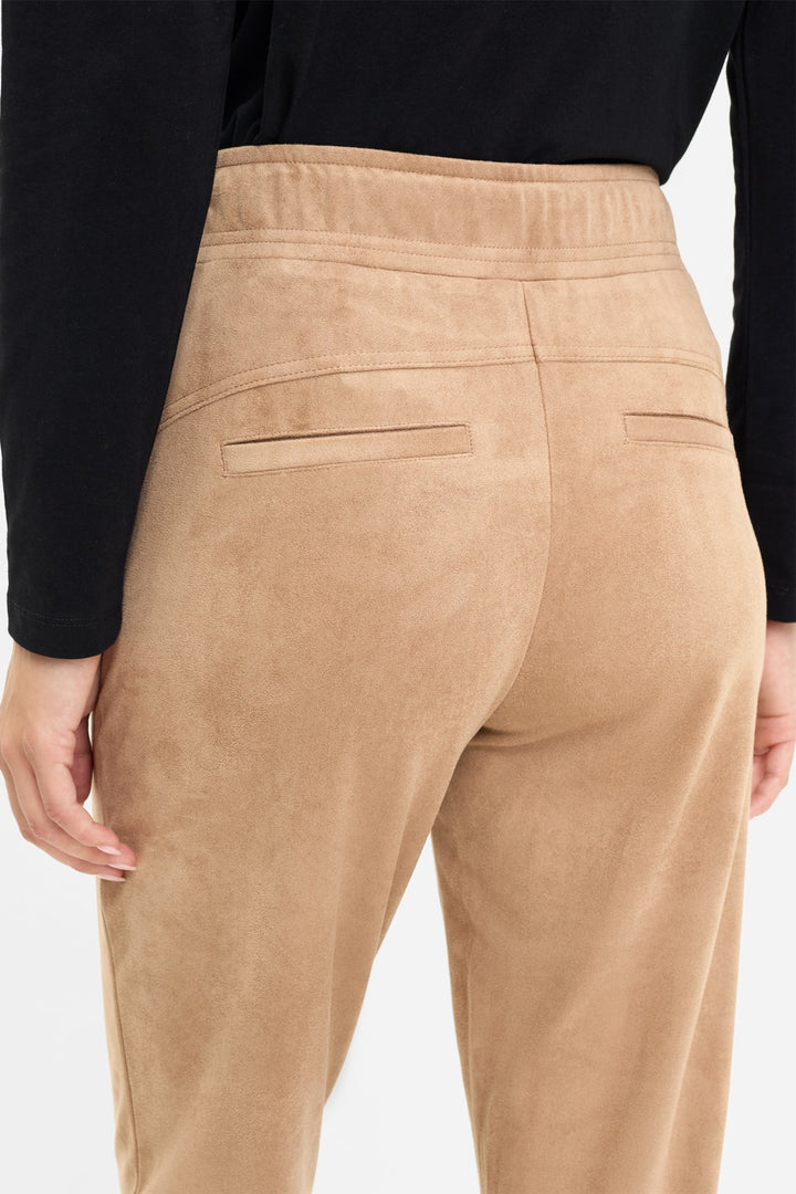 Tan pants worn by a person on a white background