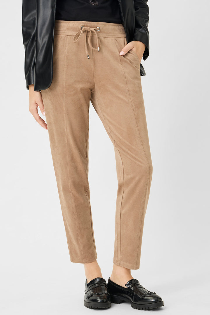 Tan pants worn by a person on a white background