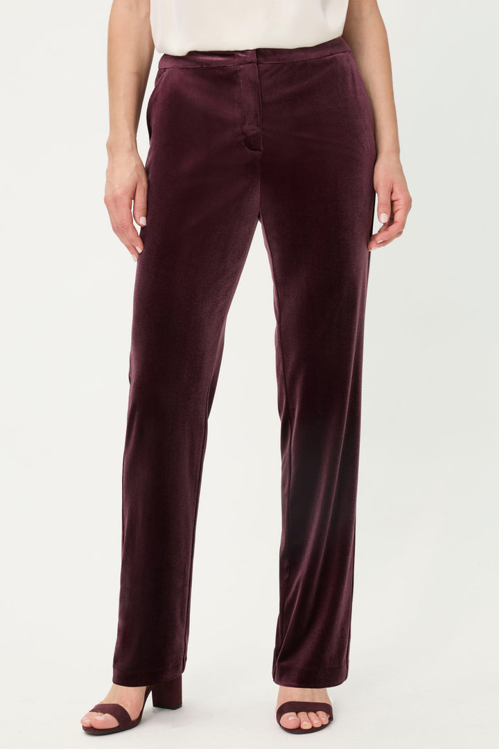 Dark wine pants worn by a person on a white background