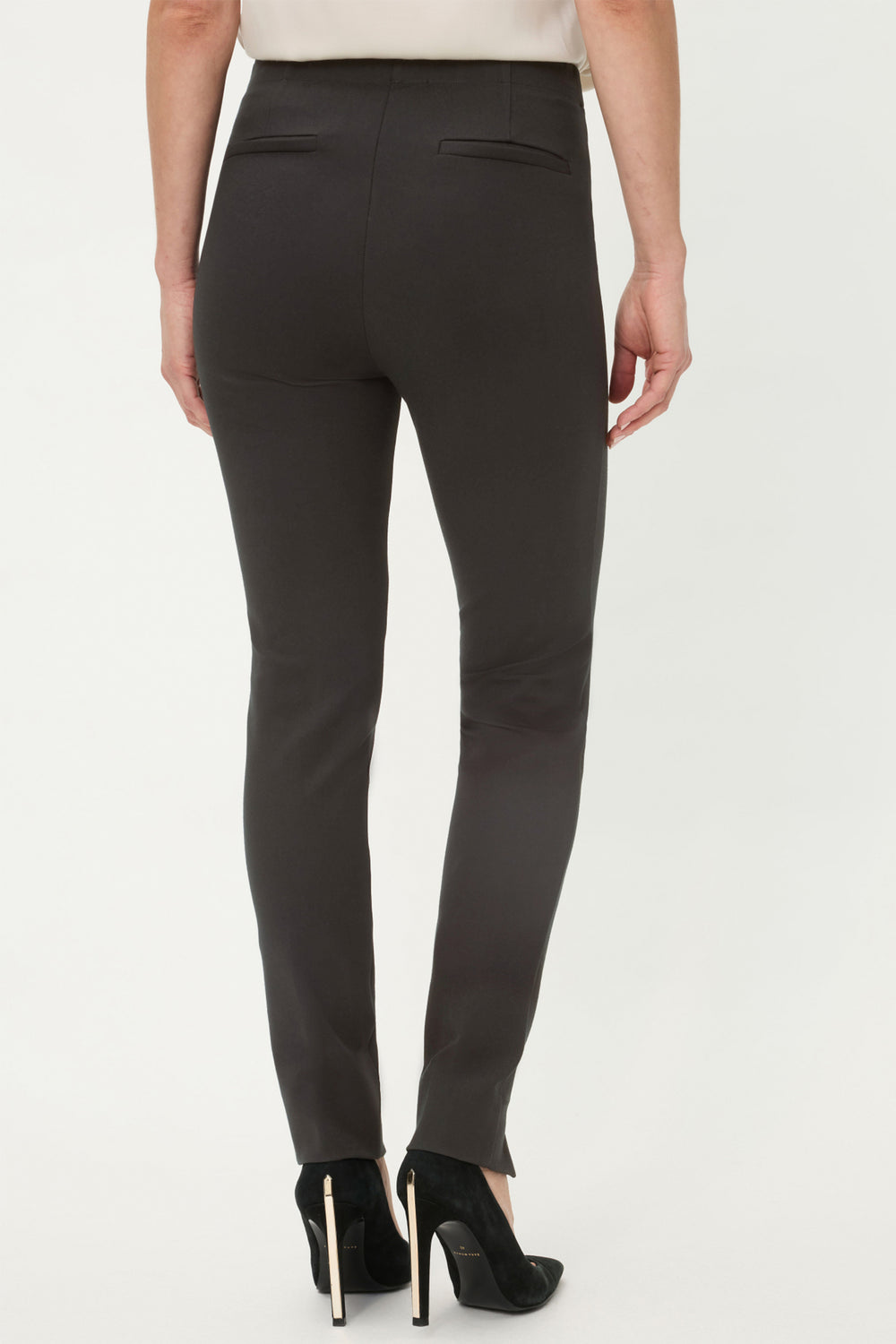 Black pants worn by a person on a white background