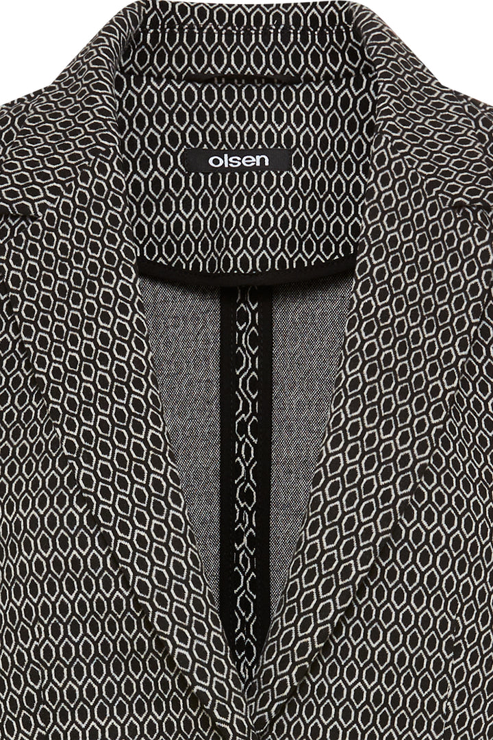 Close-up of a patterned garment with 'oliven' branding on a black background