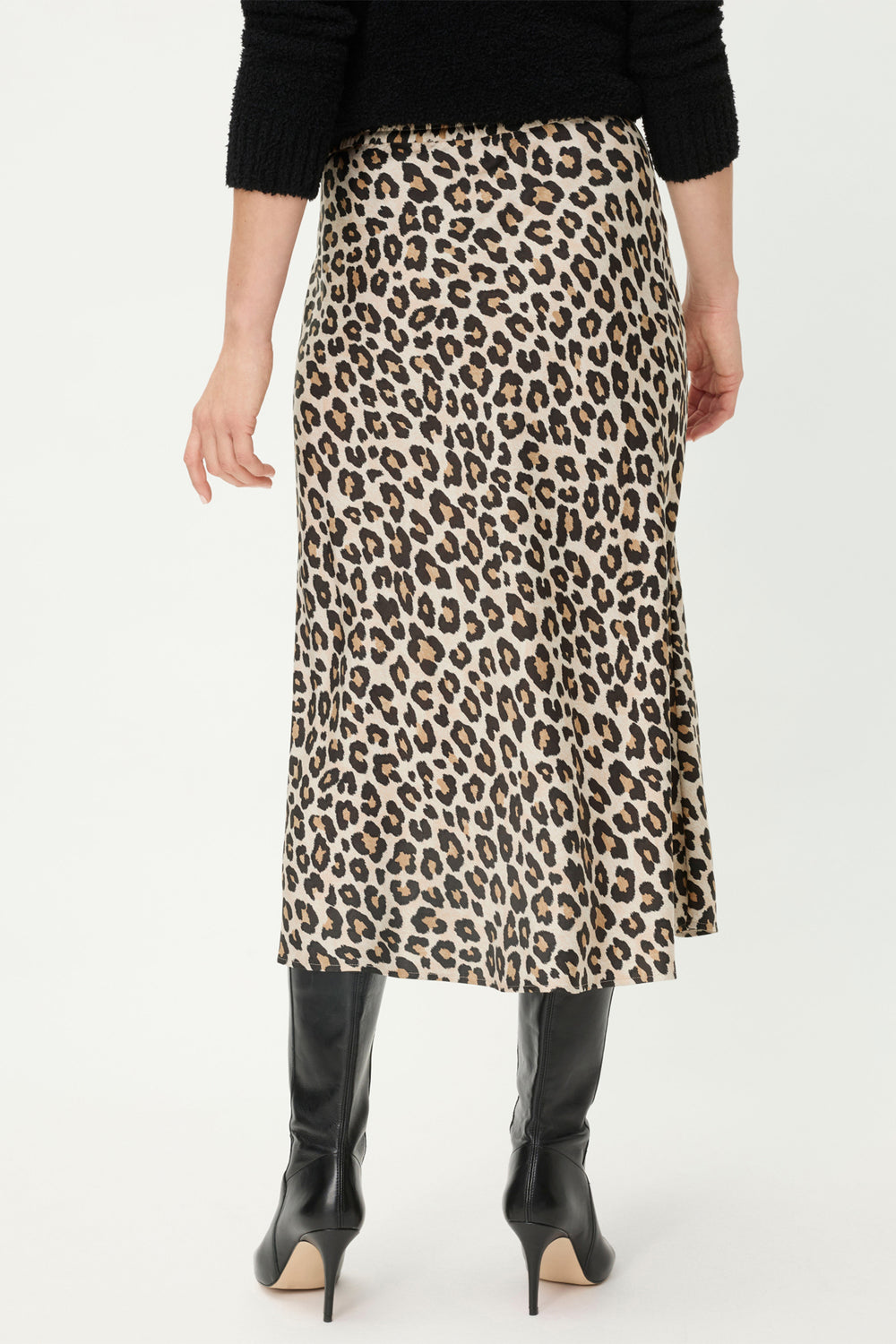Person wearing a leopard print skirt on a white background
