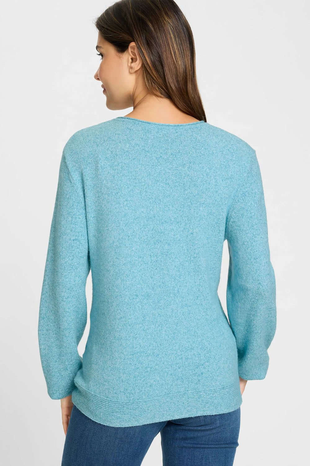 Woman wearing a light blue sweater on a white background