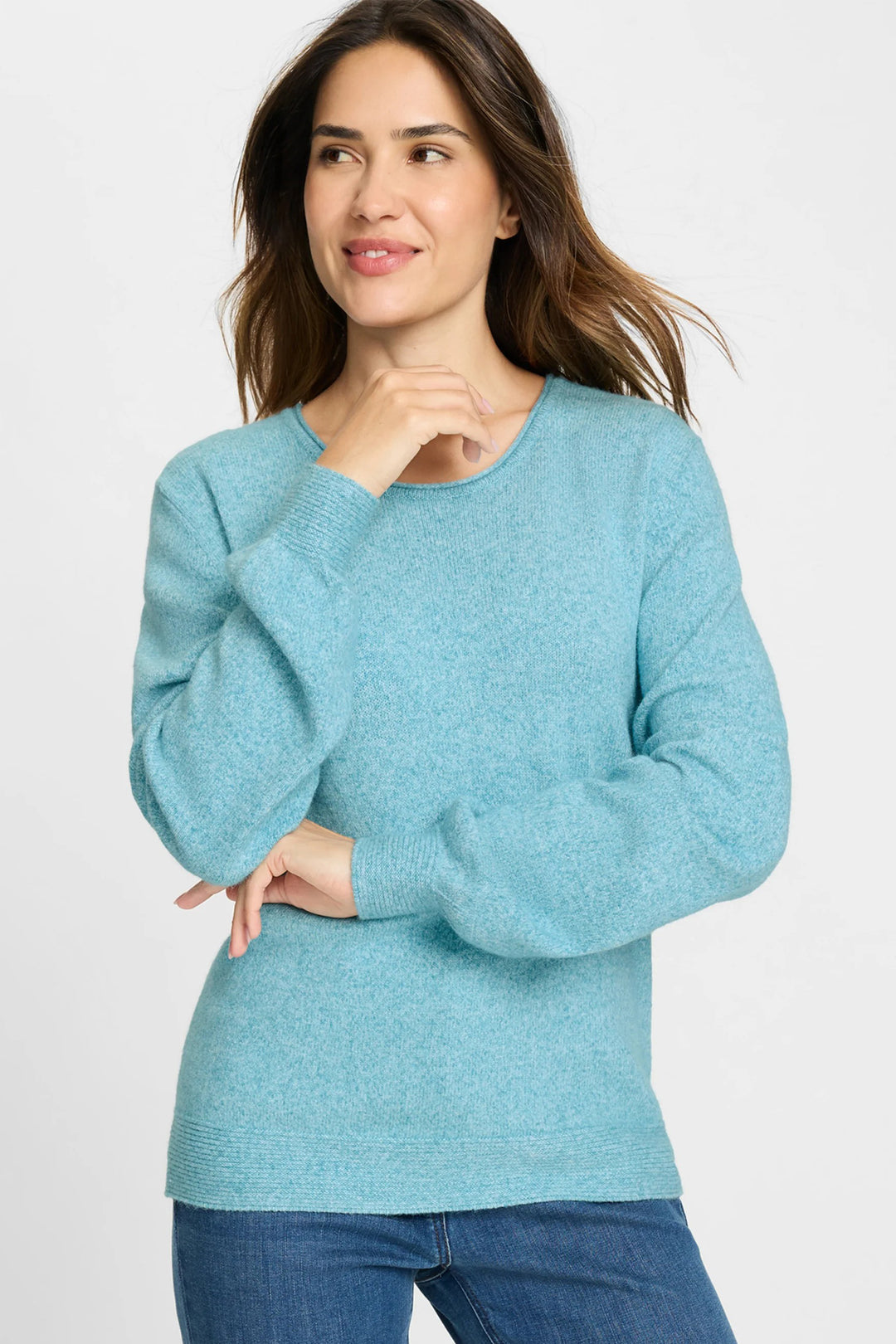 Woman wearing a light blue sweater on a white background