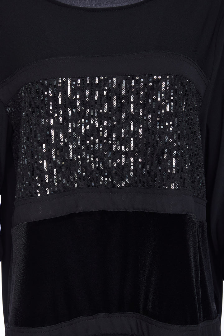 Black top with sequin detail on a plain background