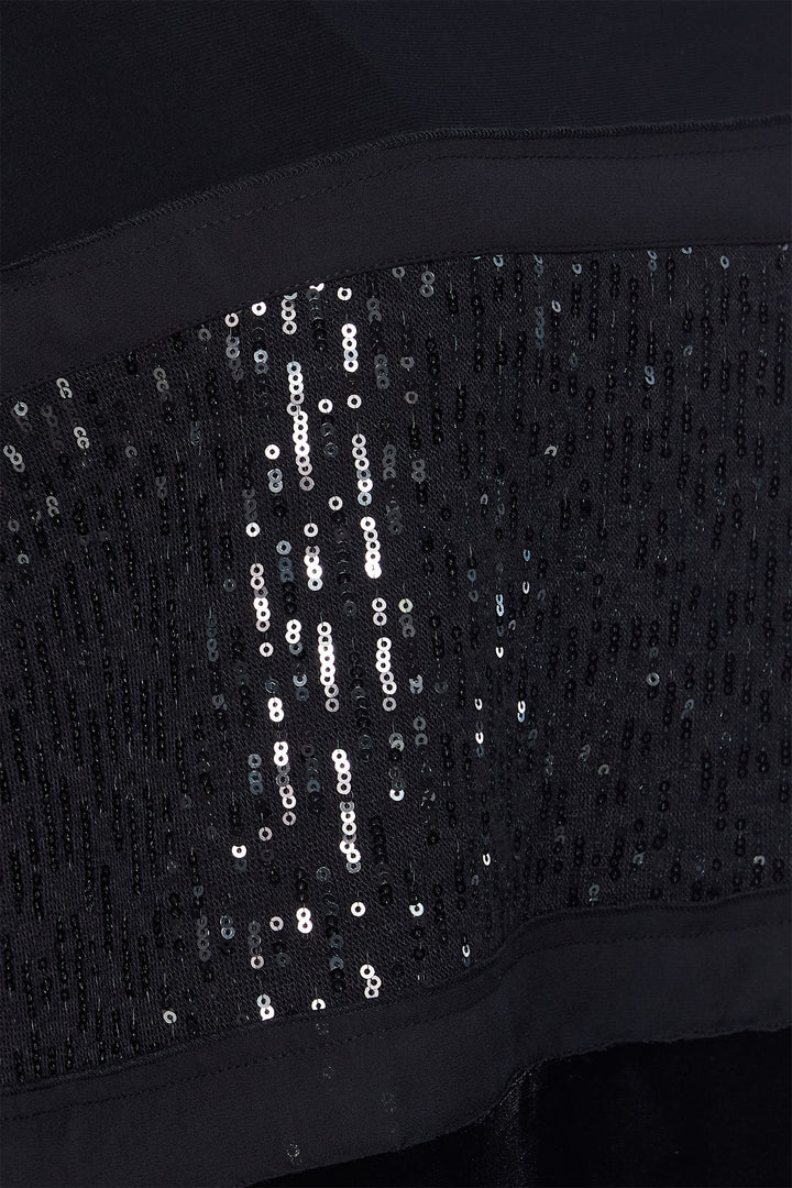 Black sequin fabric with 'Hobbs' branding on a dark background
