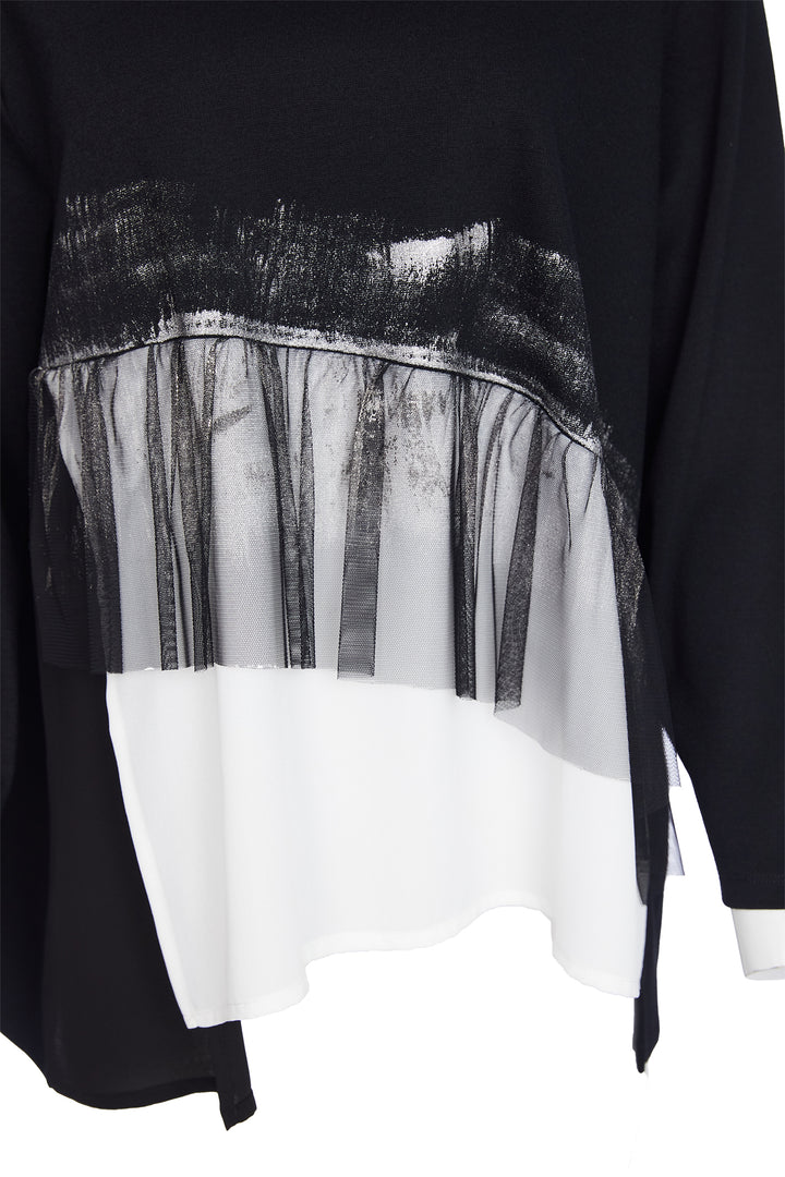 Black and white layered garment with sheer overlay