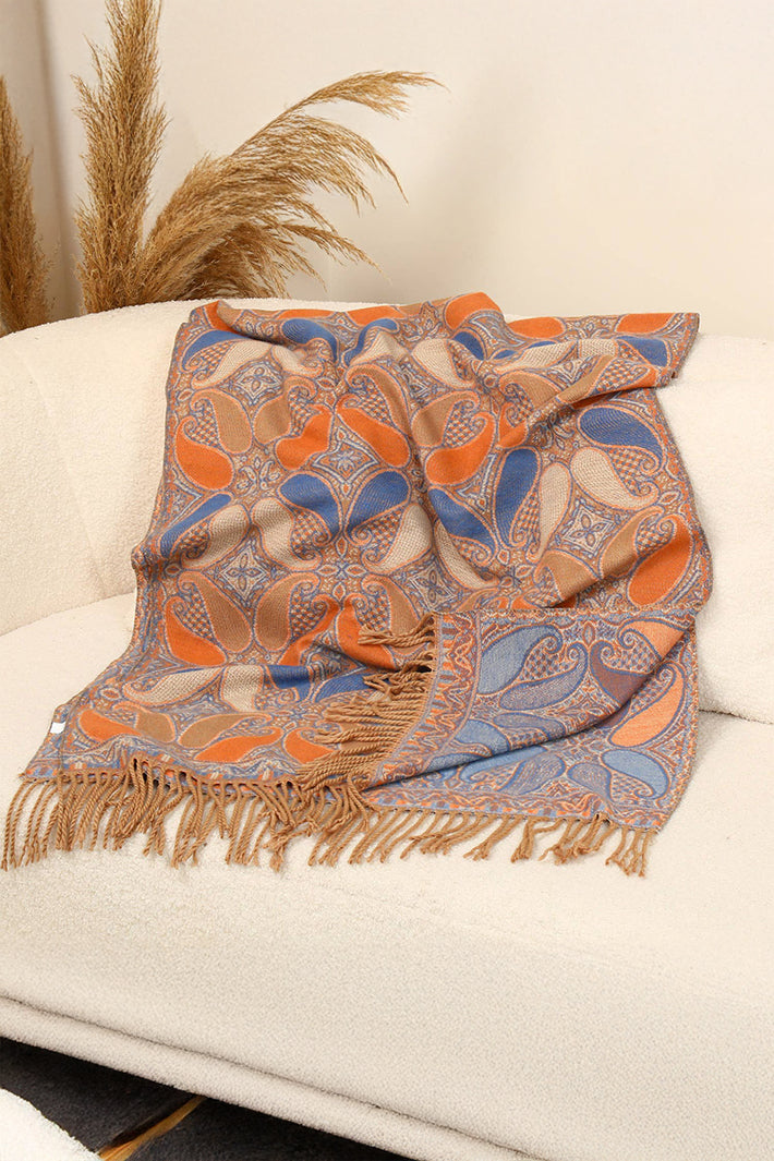 Patterned scarf with fringes on a white surface