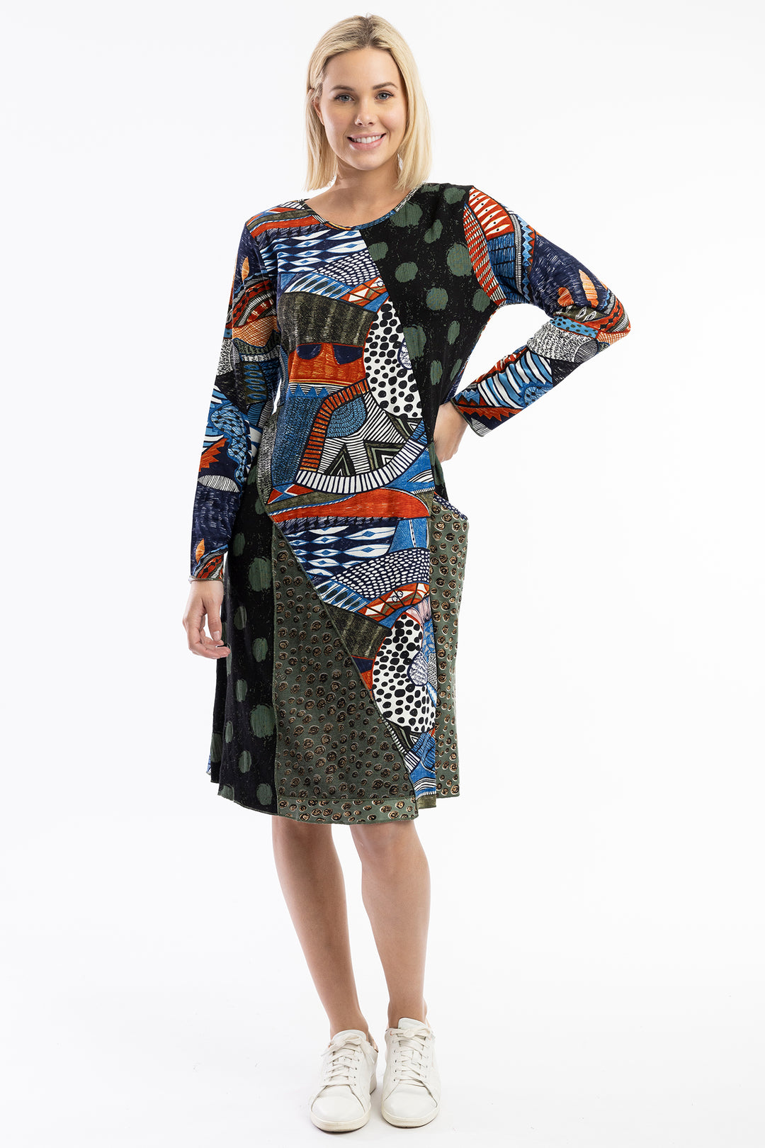 Woman wearing a colorful patterned dress on a white background