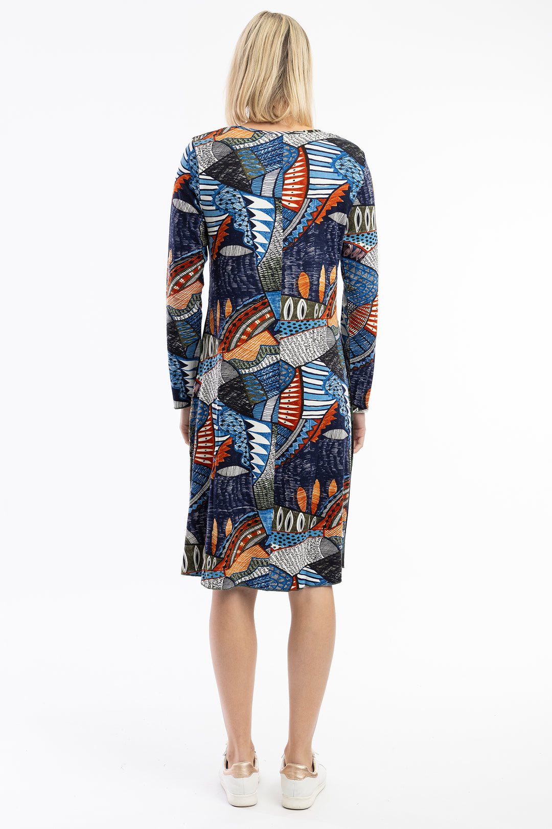 Woman wearing a colorful patterned dress on a white background