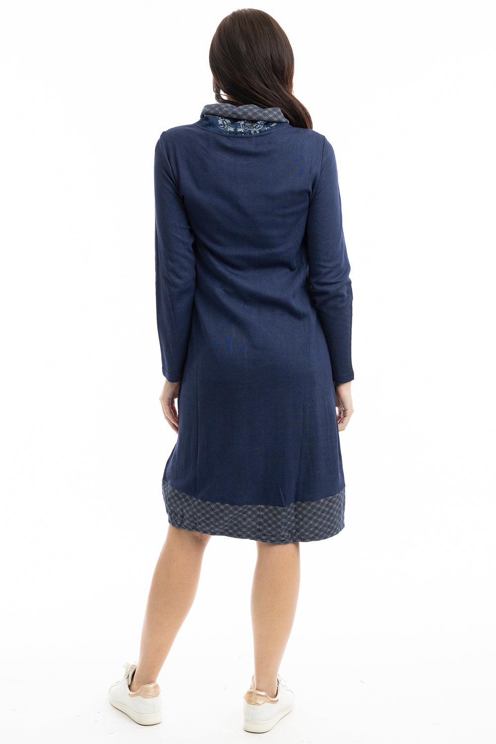 Woman wearing a blue dress with a white background