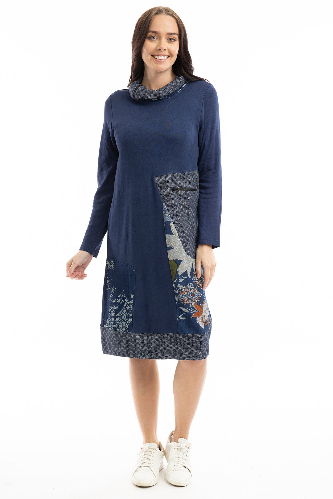 Woman wearing a blue dress with floral patterns on a white background