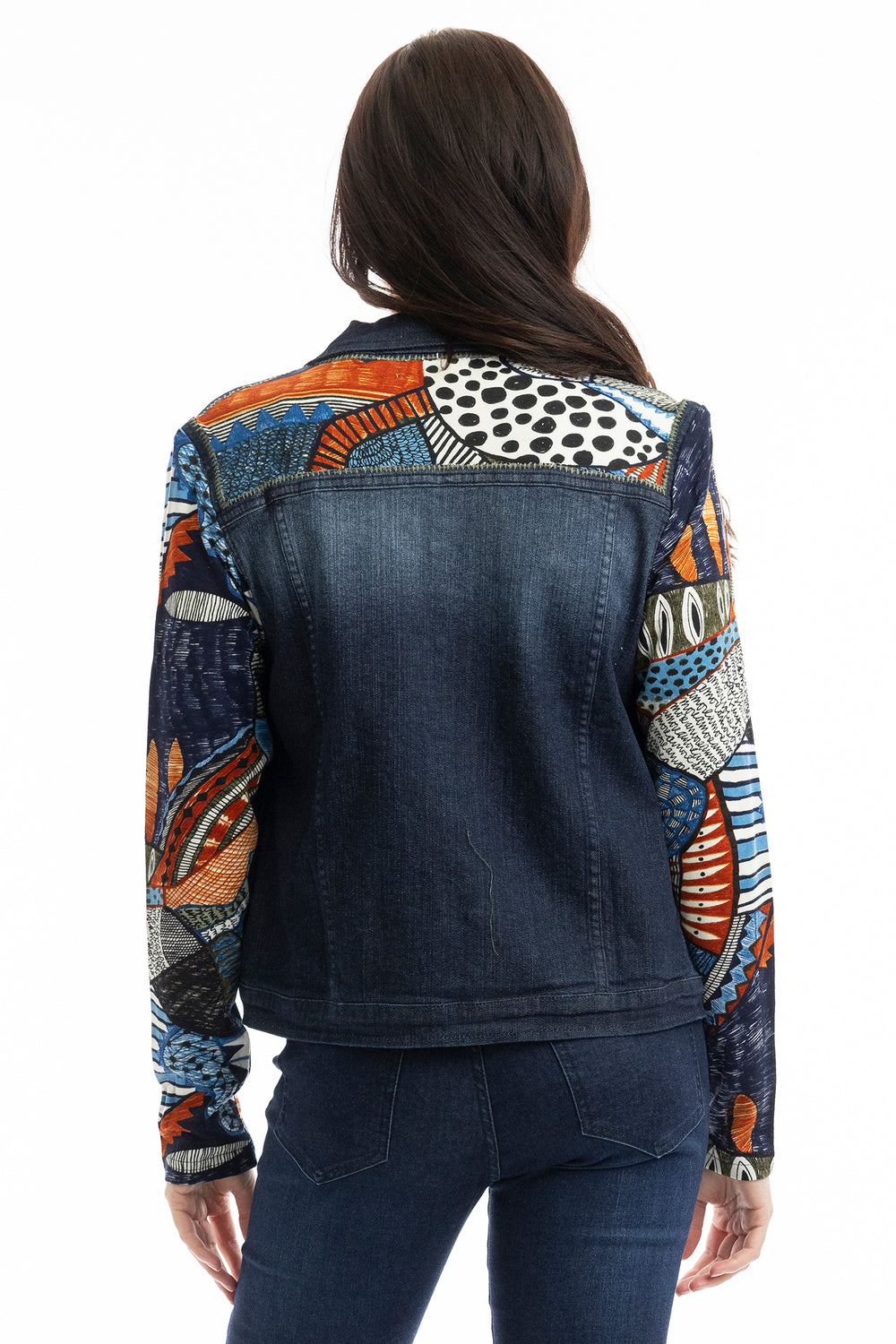 Denim jacket with colorful patterned sleeves worn by a person on a white background