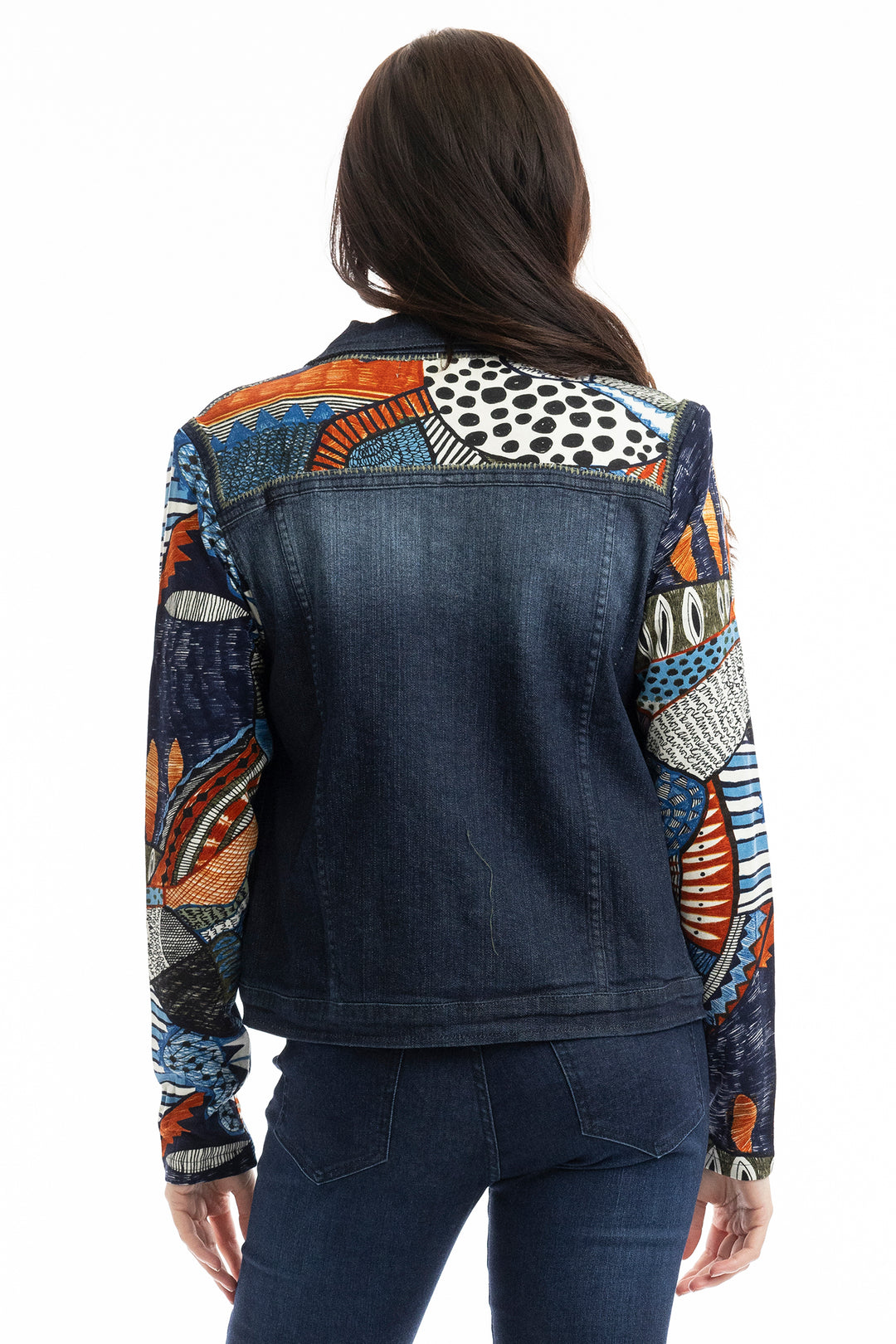 Denim jacket with colorful patterned sleeves worn by a person on a white background