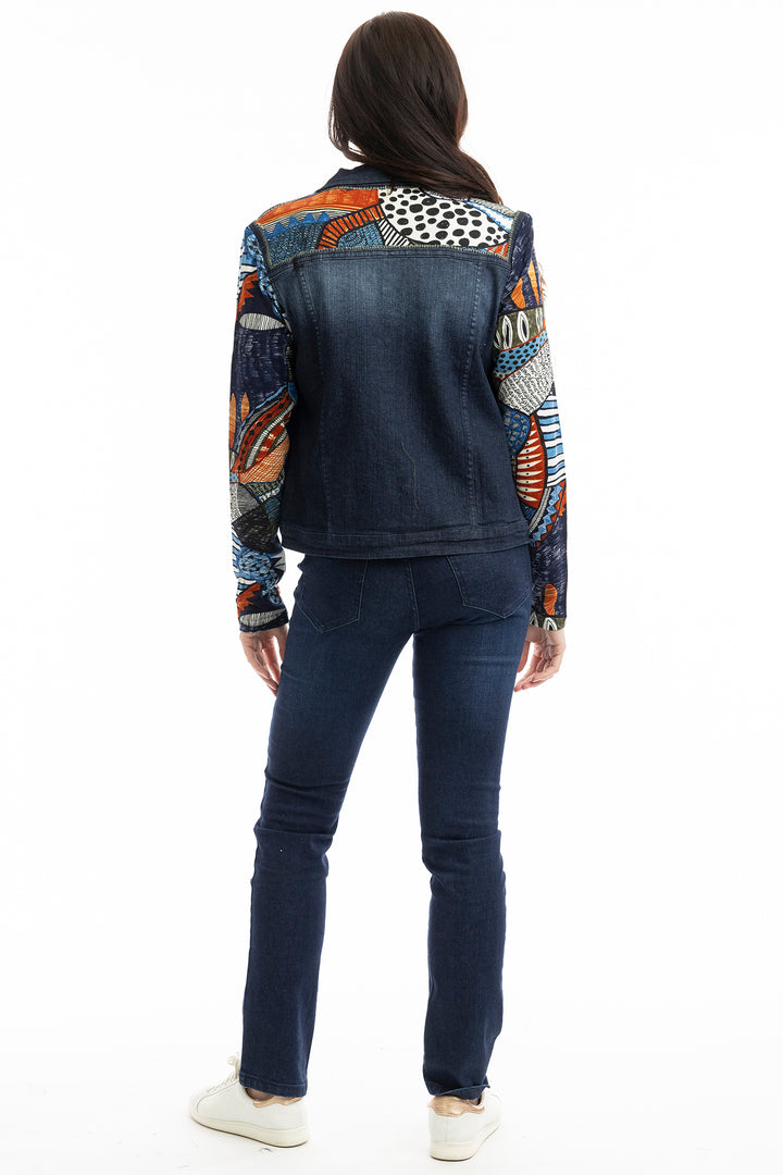 Person wearing a dark denim jacket with colorful patterned sleeves on a white background