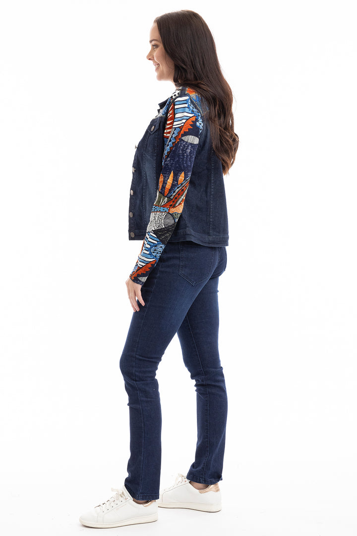 Woman wearing a patterned shirt and blue jeans on a white background