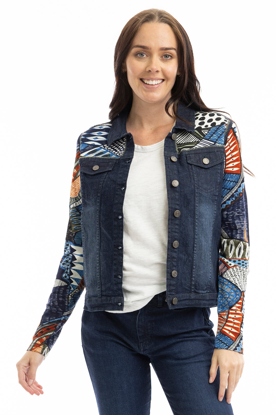 Woman wearing a colorful denim jacket with a white background