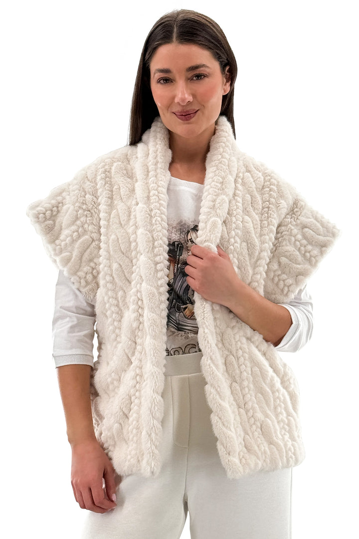 Woman wearing a cream-colored knitted vest on a white background