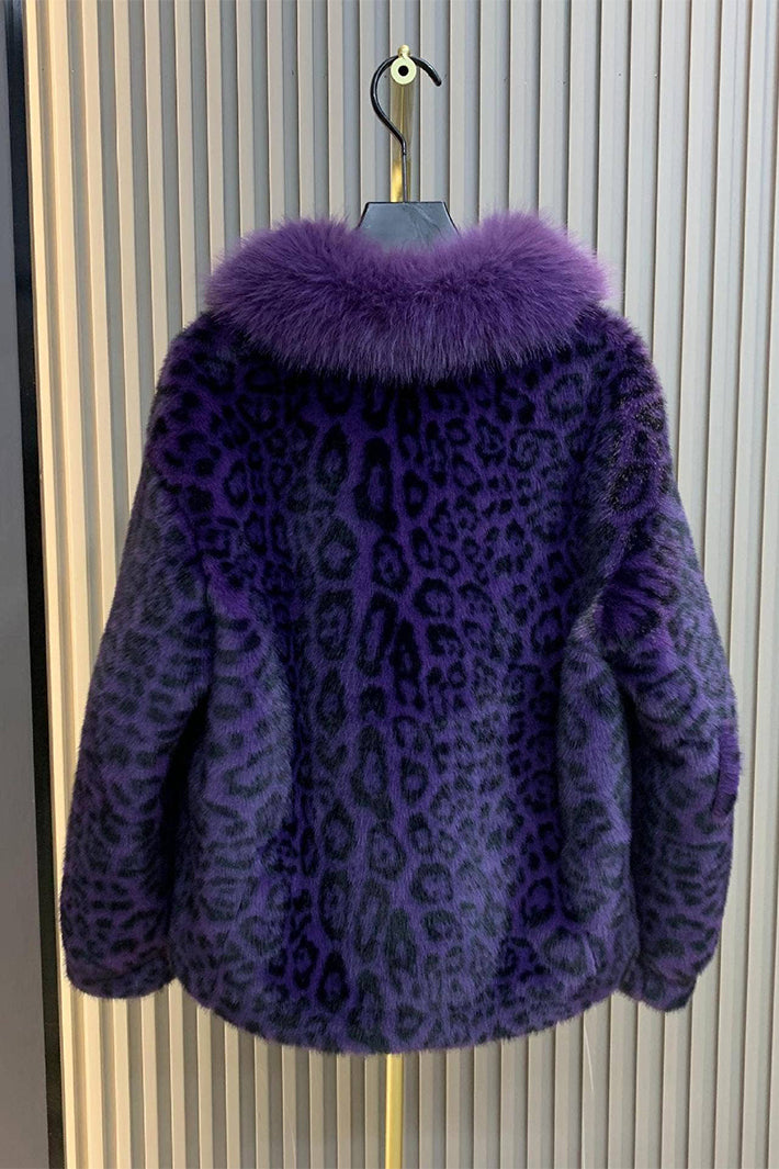 Purple leopard print coat with fur collar on a hanger against a striped background