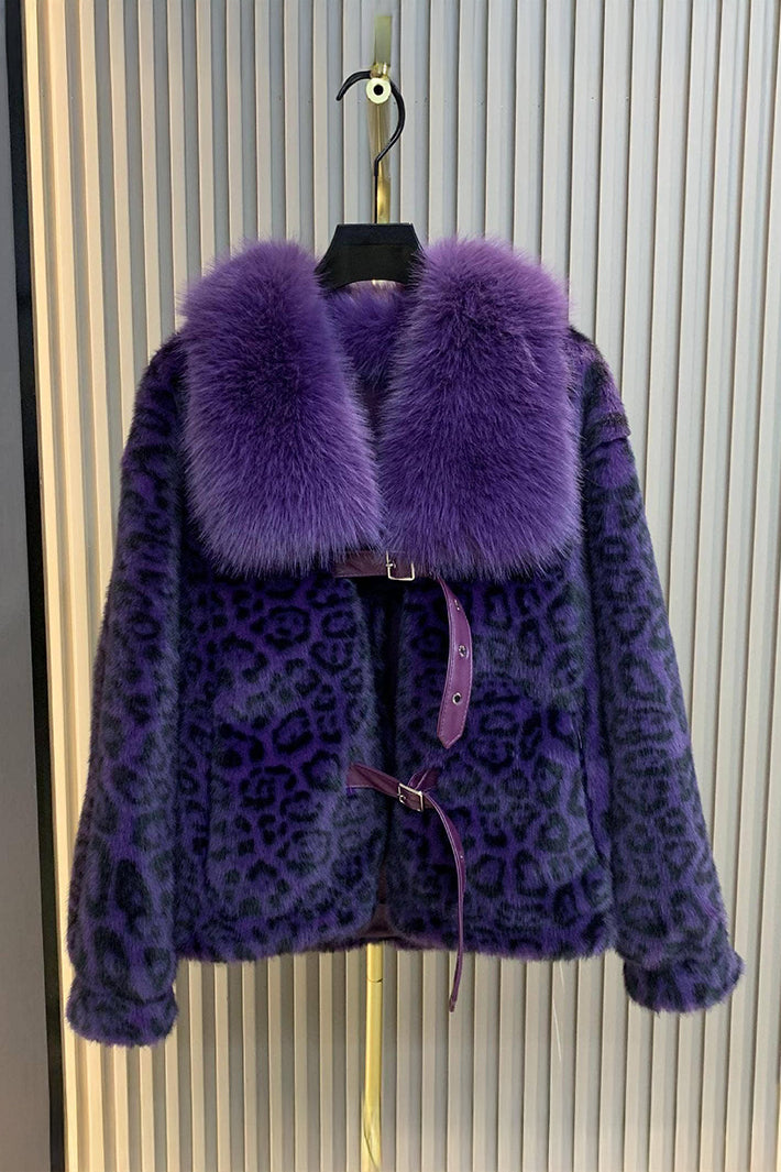 Purple leopard print coat with fur collar on a hanger against a striped background