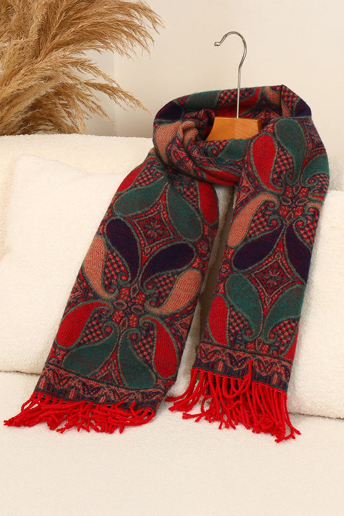 Patterned scarf with red and green design on a white surface
