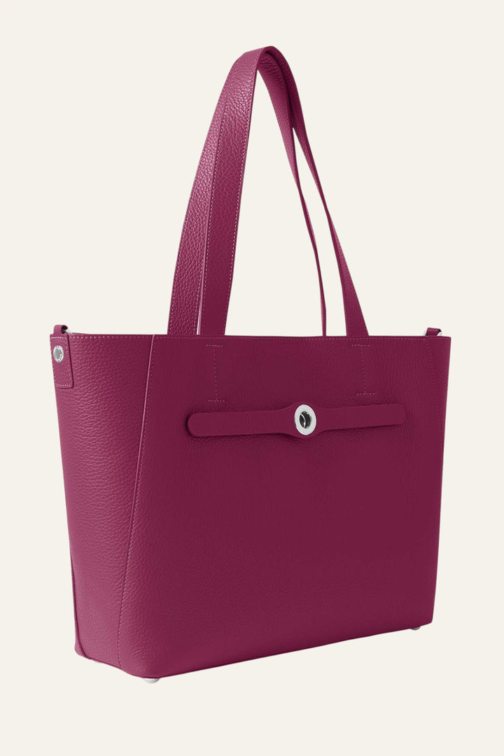Pink tote bag with a strap on a light beige background