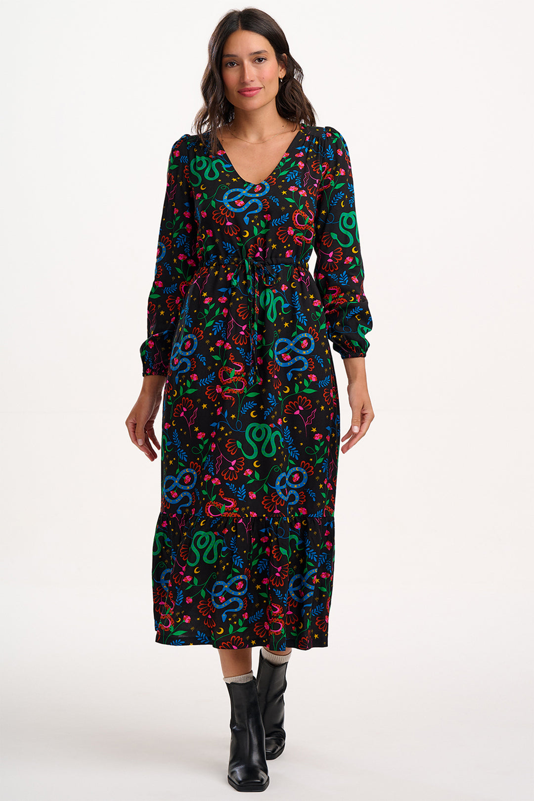 Woman wearing a colorful patterned dress on a white background