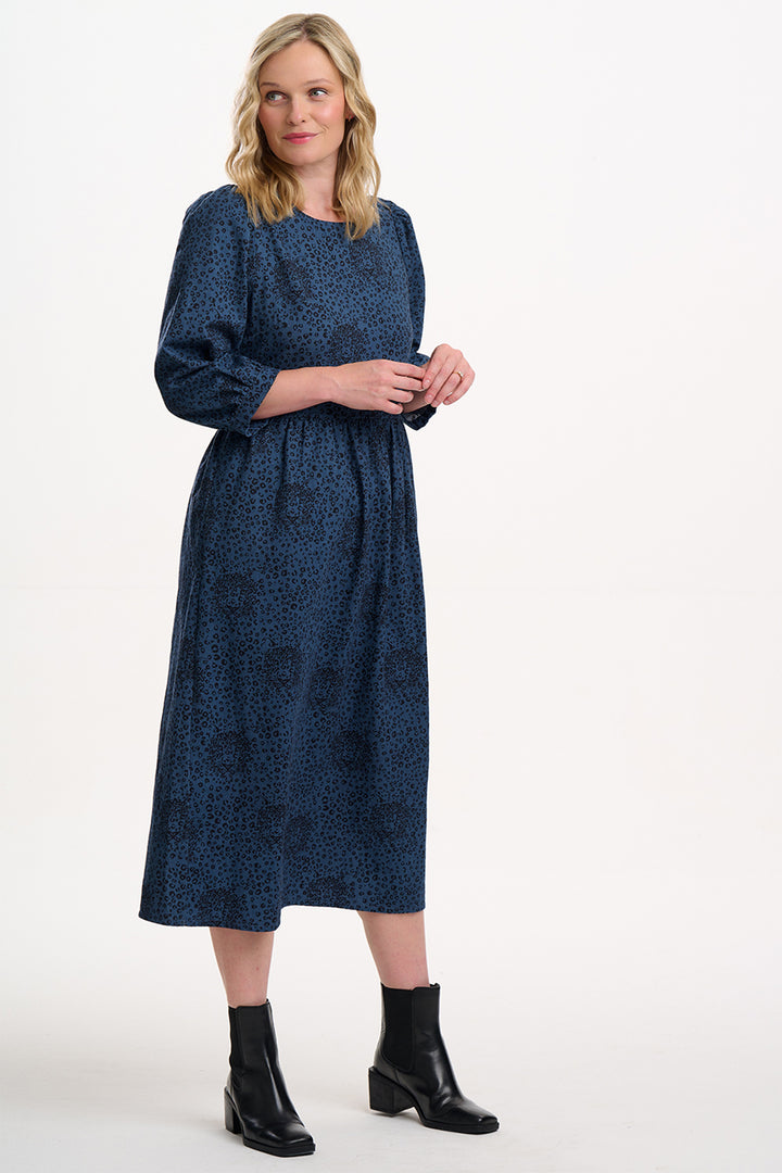 Woman wearing a blue dress with a white background