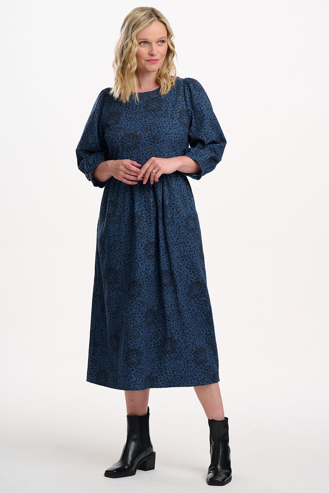 Woman wearing a blue dress with a white background