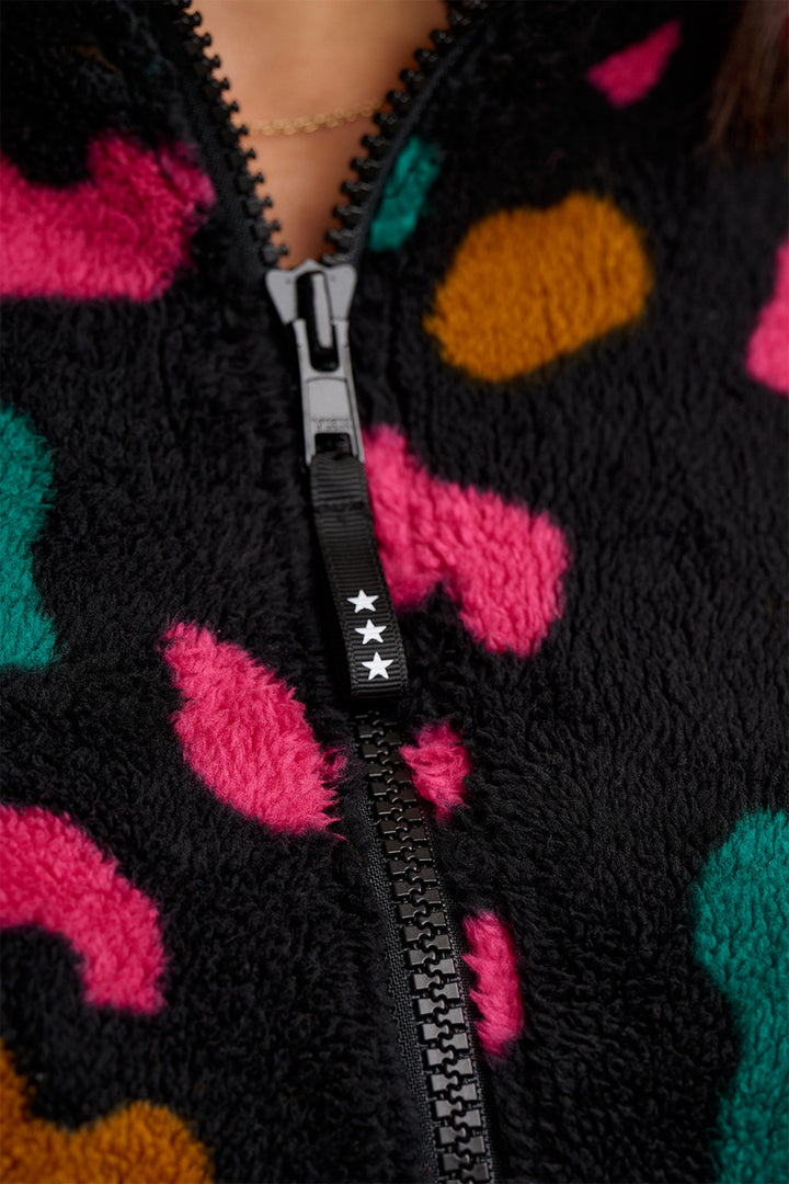 Close-up of a colorful patterned garment with a zipper.
