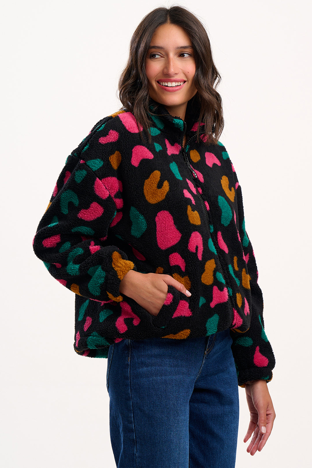 Woman wearing a colorful patterned sweater on a white background