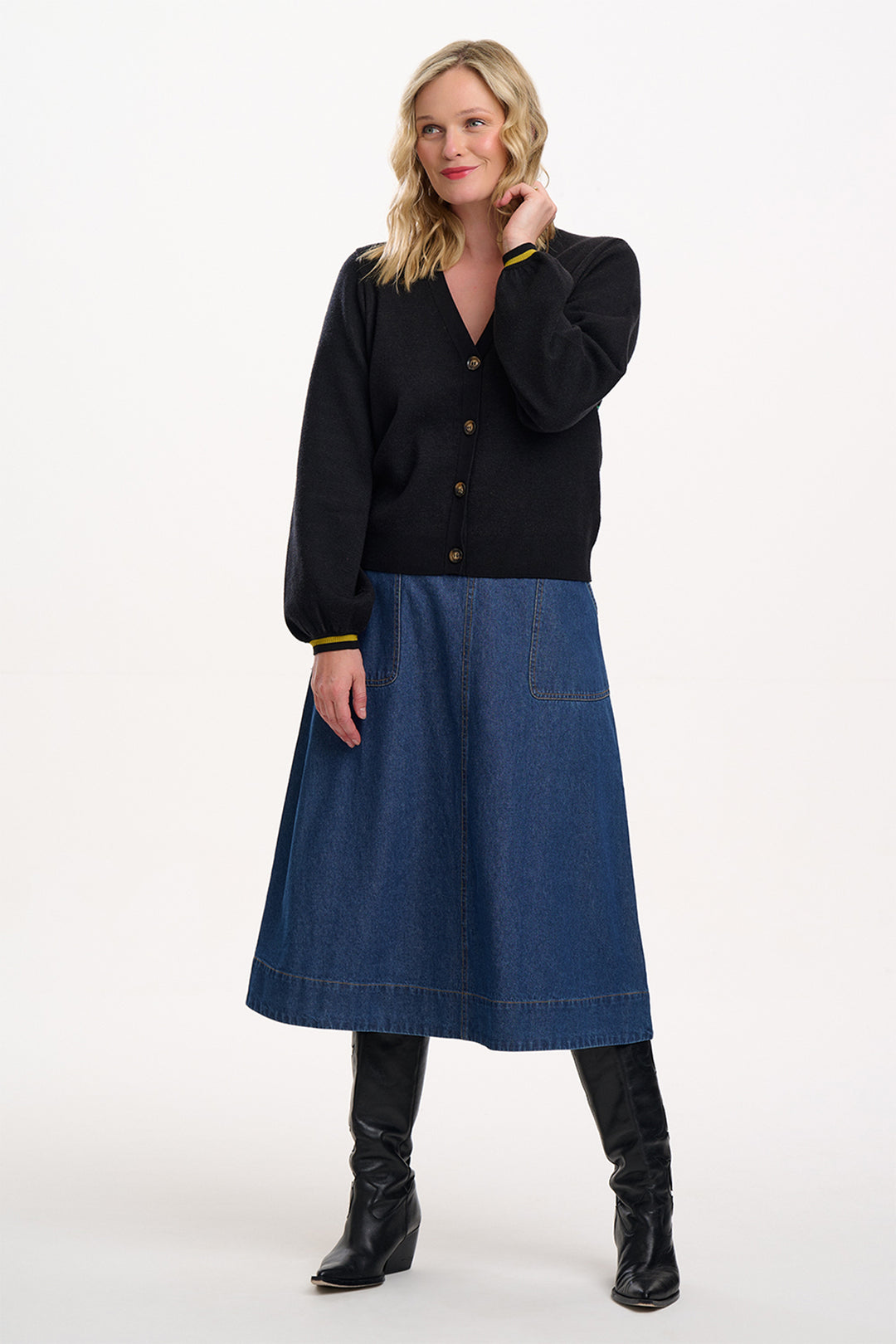 Woman wearing a black shirt and blue denim skirt on a white background