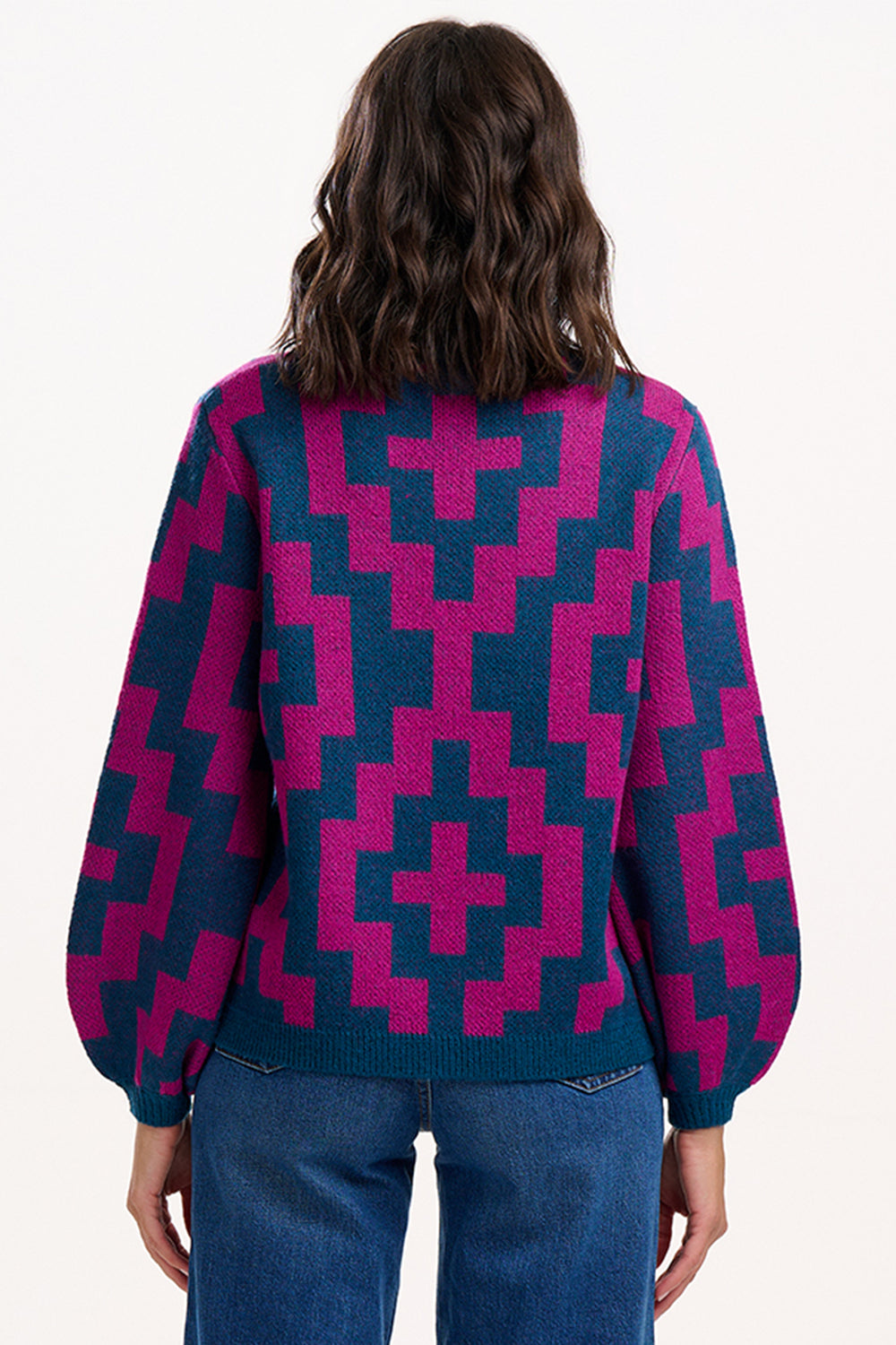 Person wearing a patterned sweater with a white background