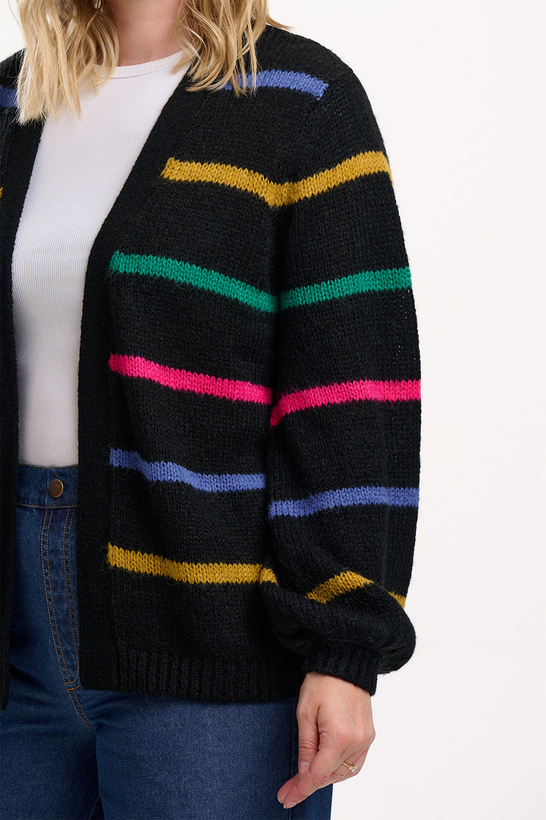 Black cardigan with colorful stripes worn by a person on a white background